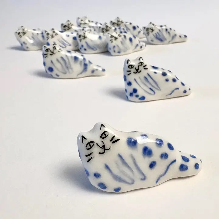 Handcrafted tiny blue leopard cat figurine with smiling face and paw prints
