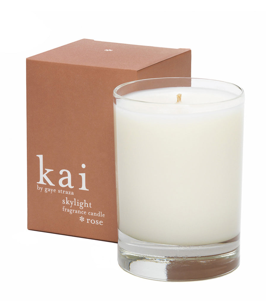 White rose fragrance candle in clear glass tumbler, with small visible flame