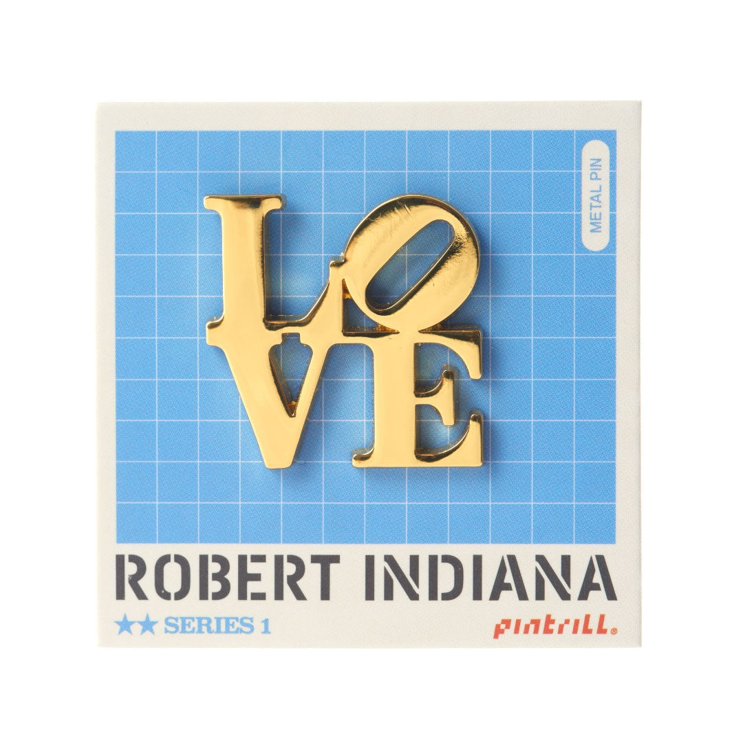 Gold LOVE lapel pin on blue grid backing card