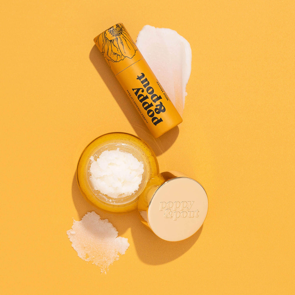 Wild Honey lip care duo flat lay: balm jar, lip scrub tube, and sugar exfoliant