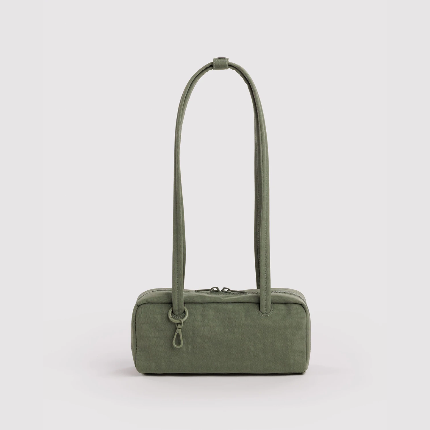 Small nylon bowler bag in caper green, top handles and front zip pocket.