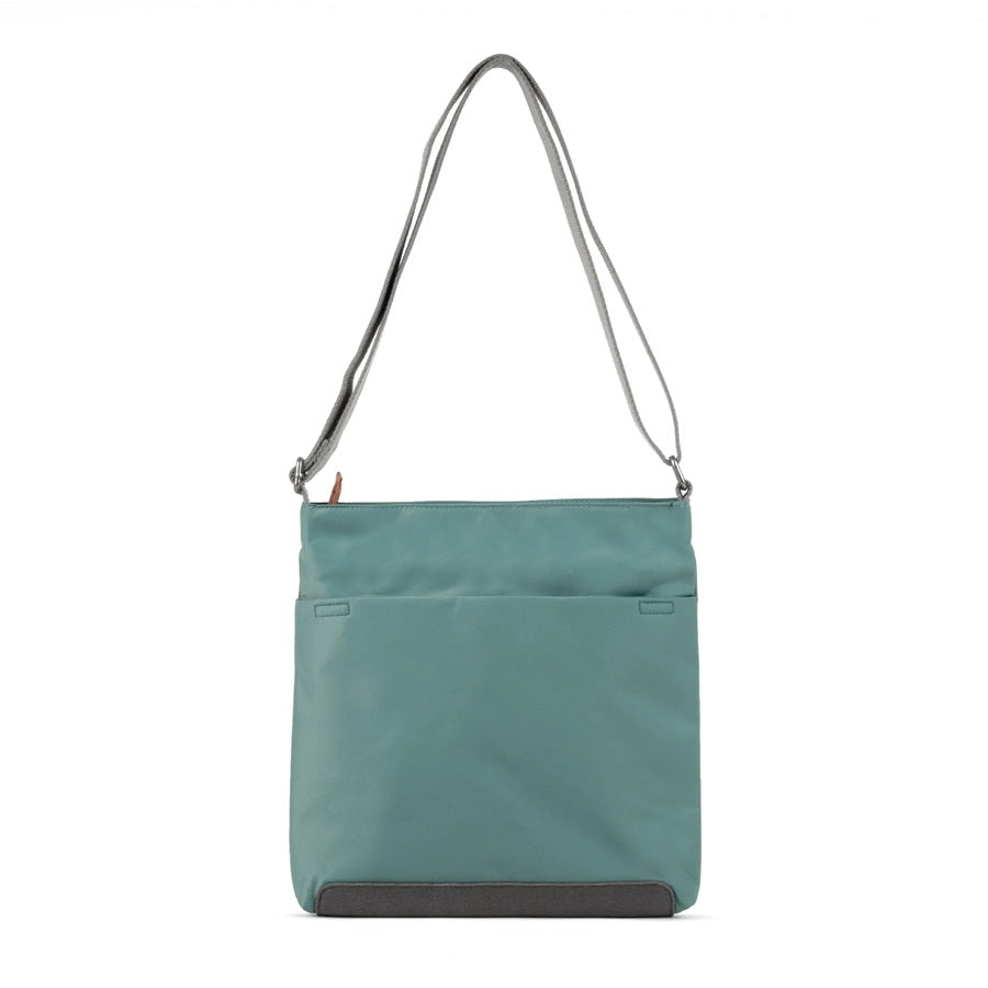 Teal nylon crossbody bag with top zipper, adjustable shoulder strap, and front pocket