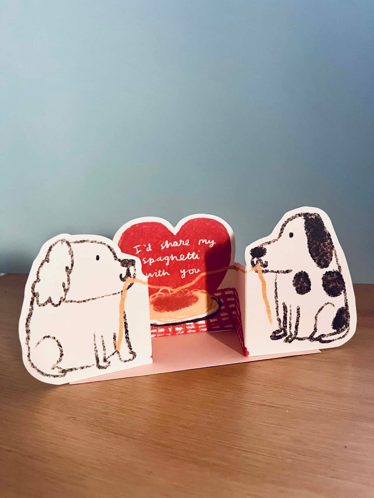 Spaghetti dogs pop-up card with two dog cutouts and red heart message, open