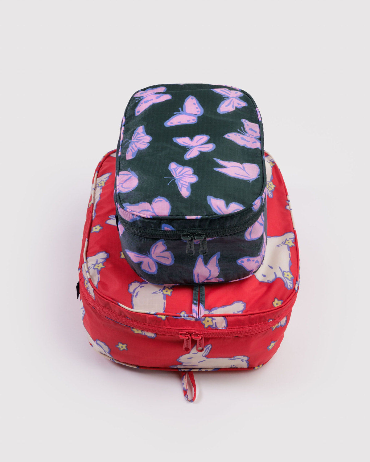 Packing cube set with dark navy top and red bottom, butterfly and animal print