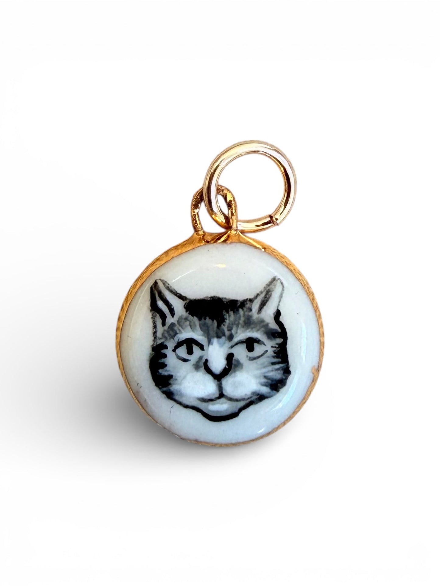 Porcelain cat charm pendant with black-and-white cat face, gold ring bail