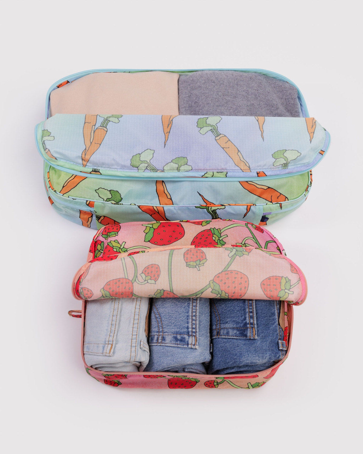 Large packing cube set with pastel animal print and folded denim inside, zipped
