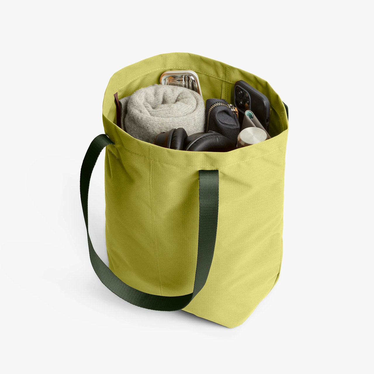 City tote bag with side pockets and handles, showing folded cloth and bottle inside.