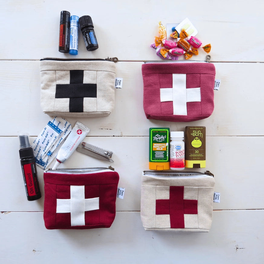 Set of four medium first aid kit pouches with cream cross patches in black and red