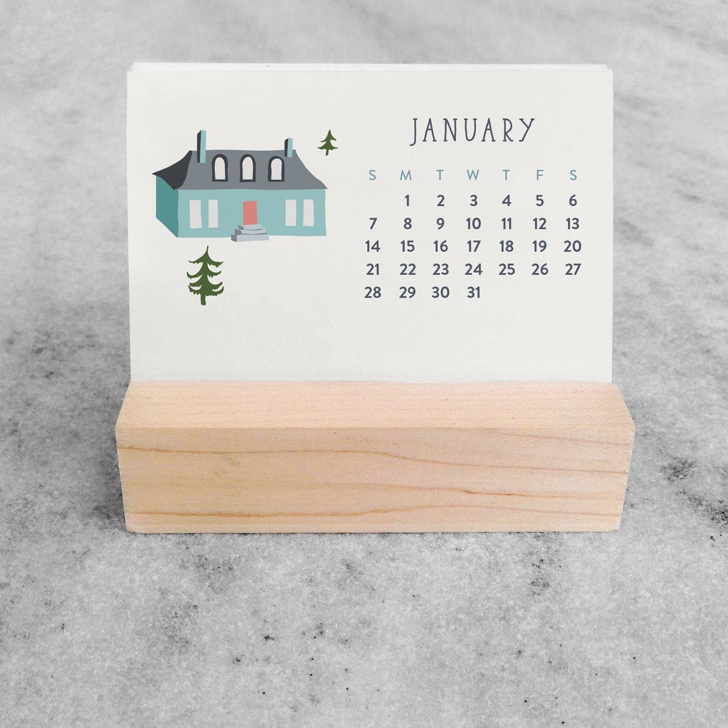 Mini desk calendar with January page, village house illustration, wooden stand base