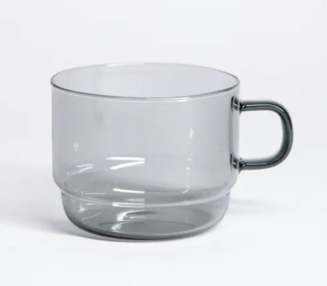 Clear gray glass stackable mug with curved handle and smooth rim