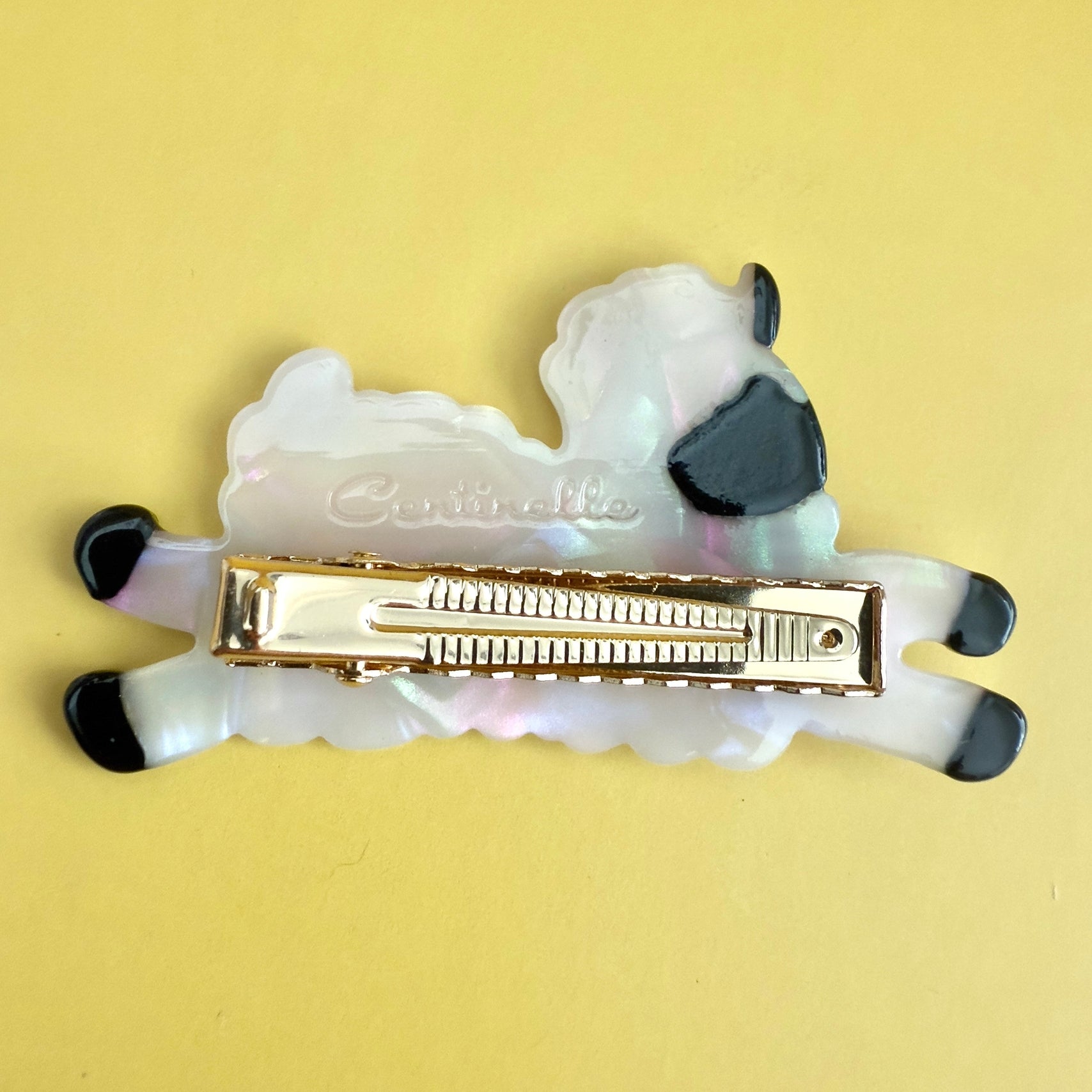 Sheep-shaped alligator hair clip with metal spring and white fur, black ears