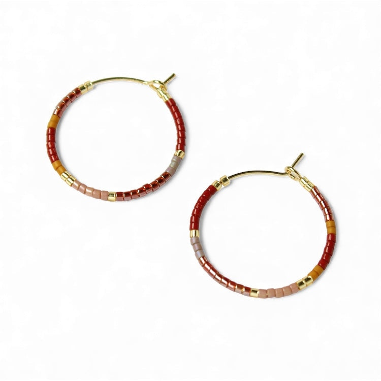 Pair of beaded hoop earrings with gold-tone hooks; red and gray beads with gold squares.