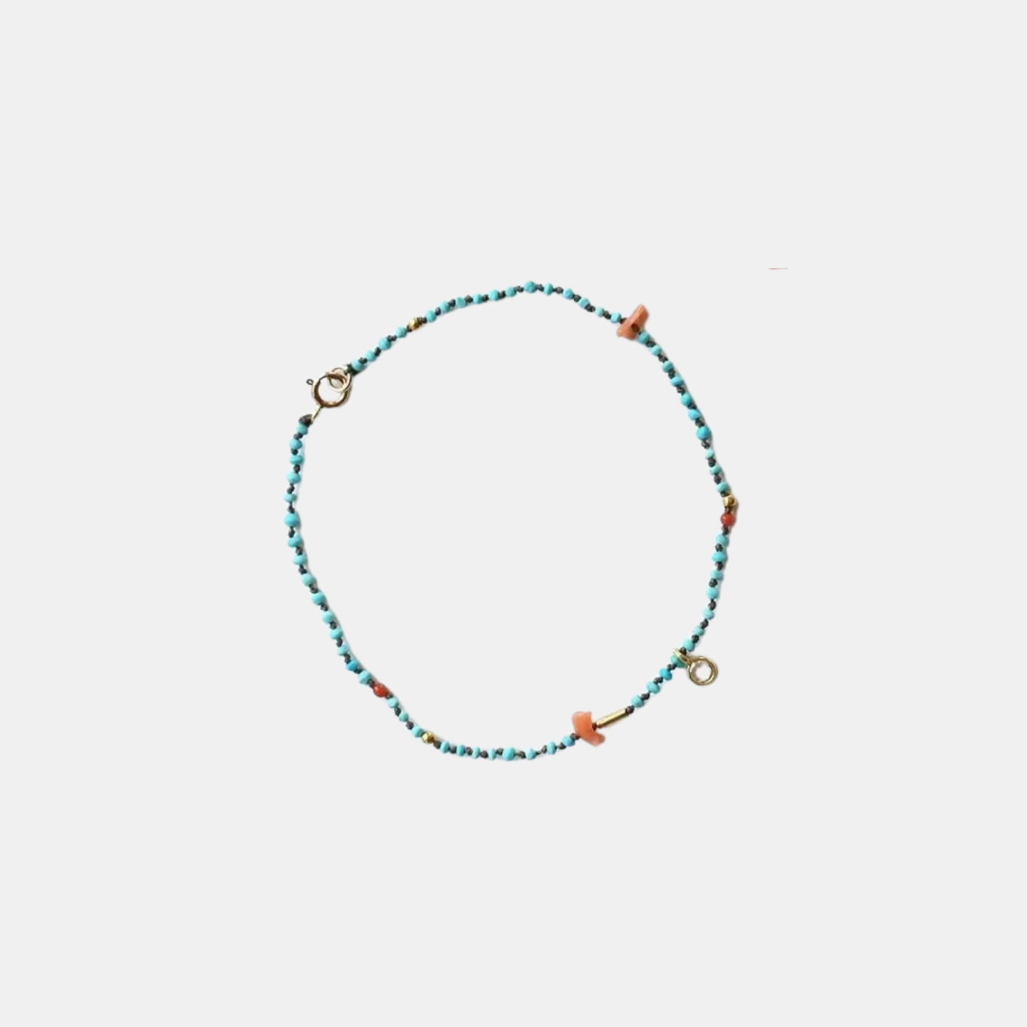 Turquoise beaded confetti bracelet with orange accents and gold clasp rings