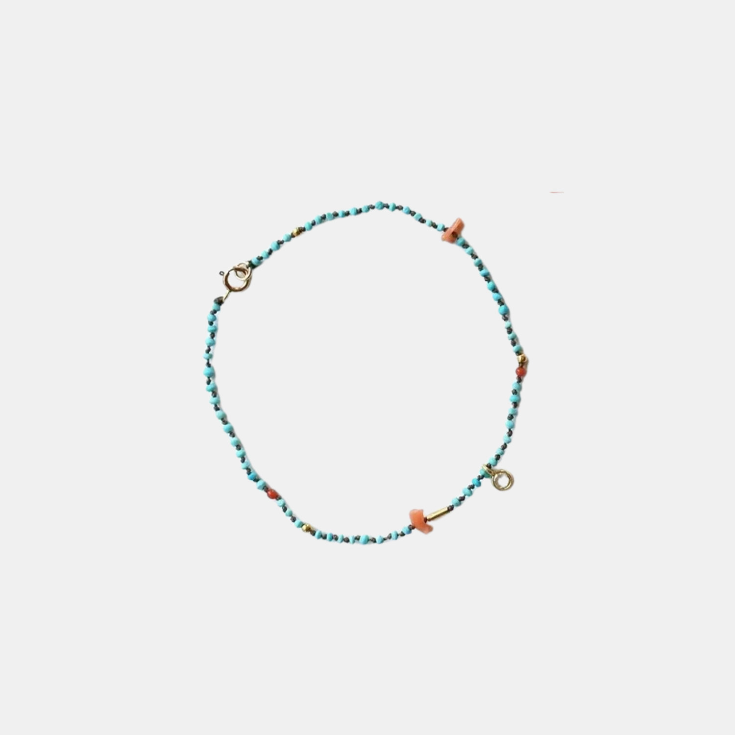 Turquoise beaded confetti bracelet with orange accents and gold clasp rings