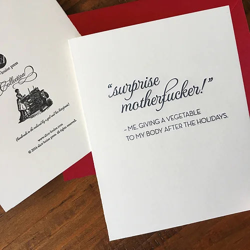 Holiday card with "Surprise motherfucker!" message on white paper