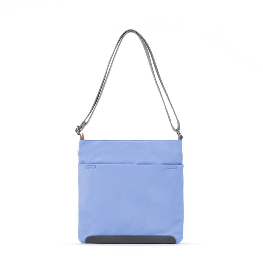 Light blue nylon crossbody bag with top zipper, adjustable shoulder strap, and front pocket