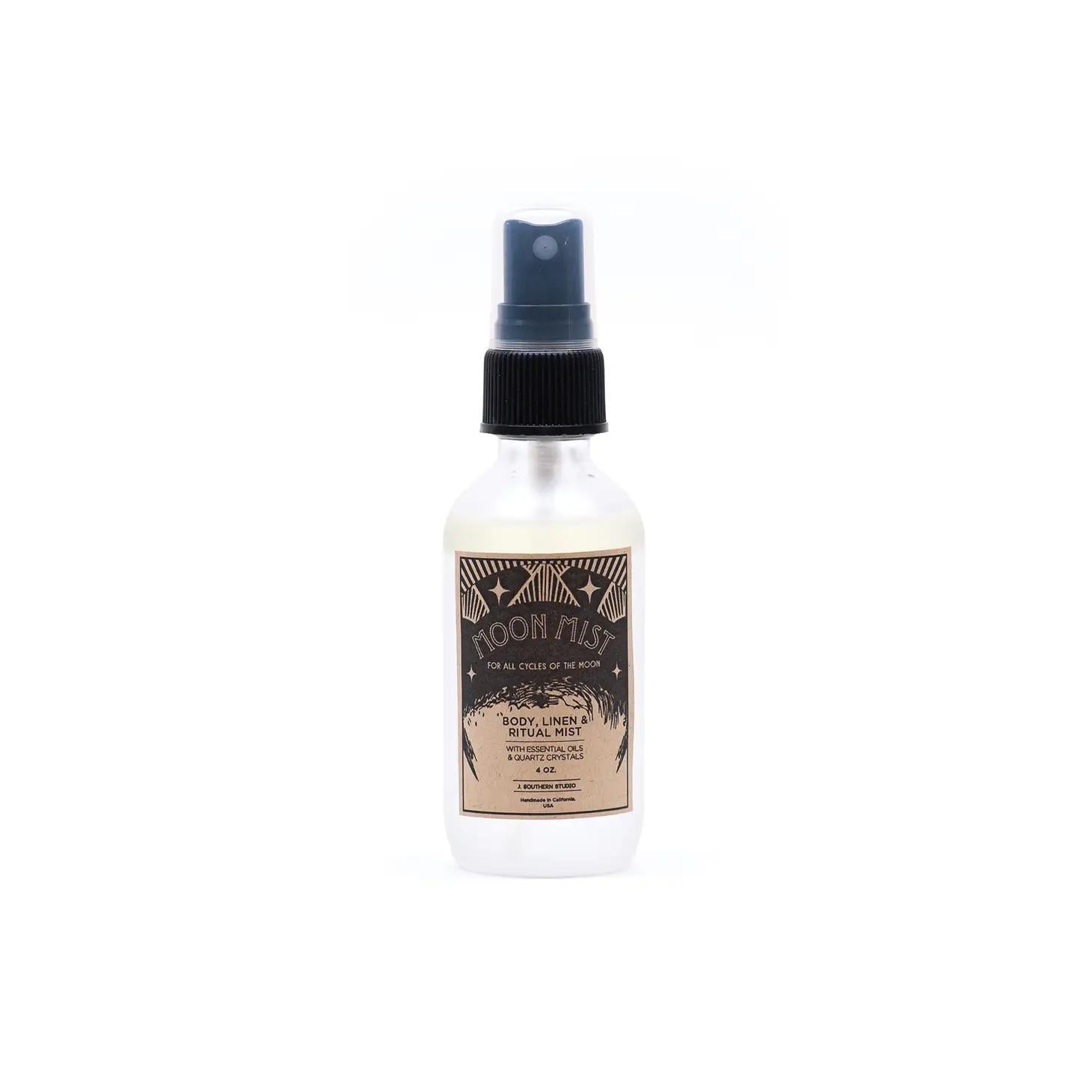 Clear glass body mist spray bottle with dark label and blue pump top
