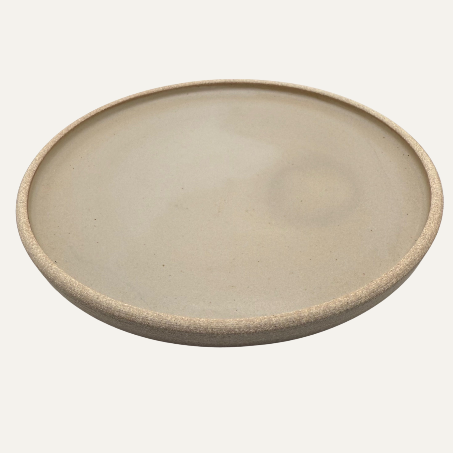 Matte glazed cream plate, 10-inch round with textured speckled rim