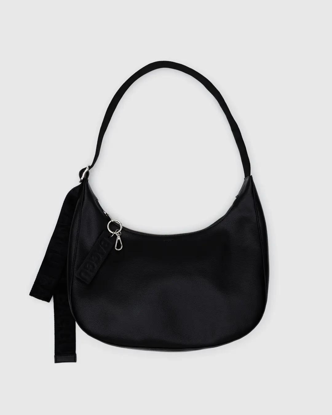 Medium recycled leather crescent bag in black, zip top, shoulder strap with tassel