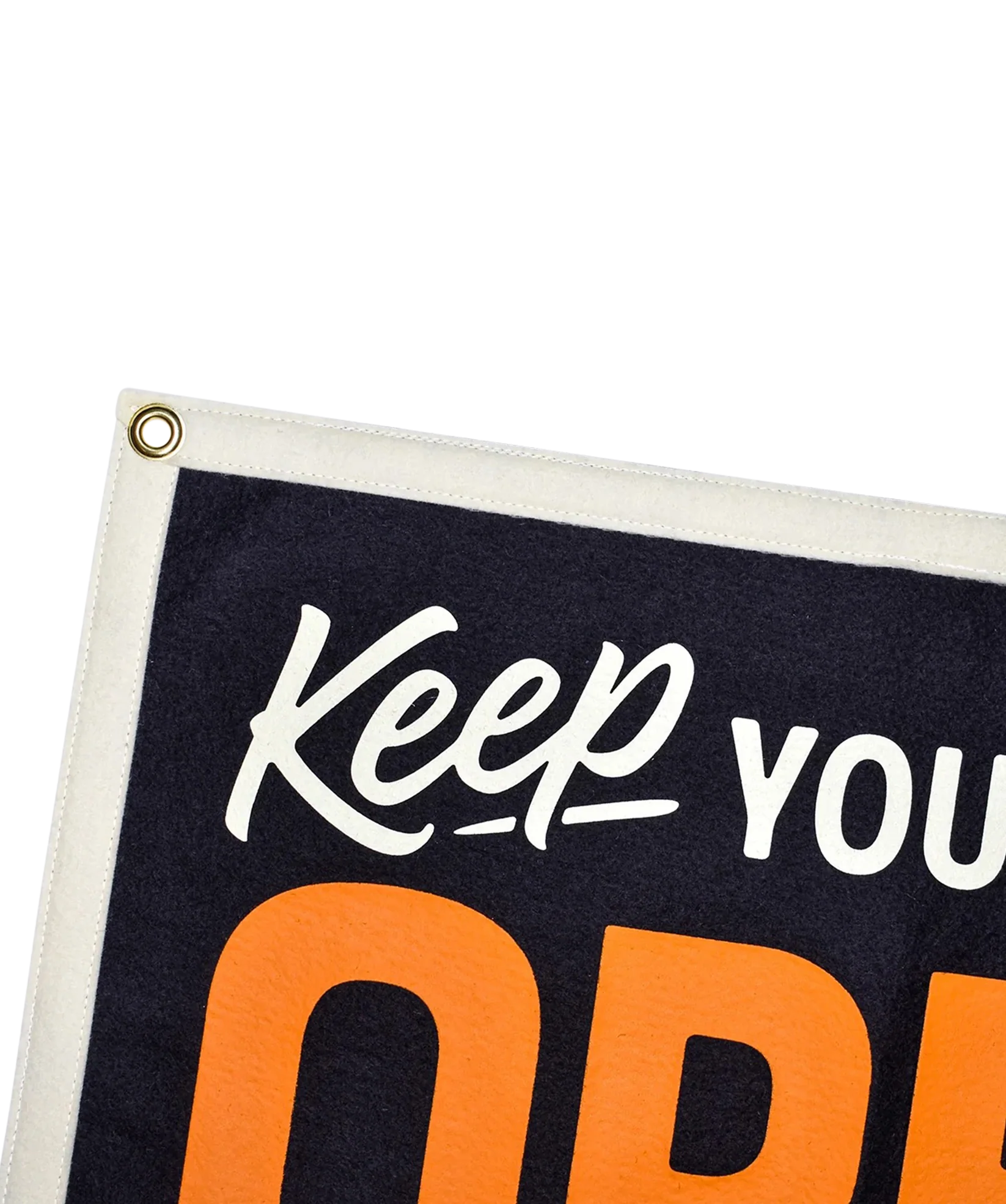 Camp flag close-up with white 'Keep your mind' script and orange 'OPEN', brass grommet