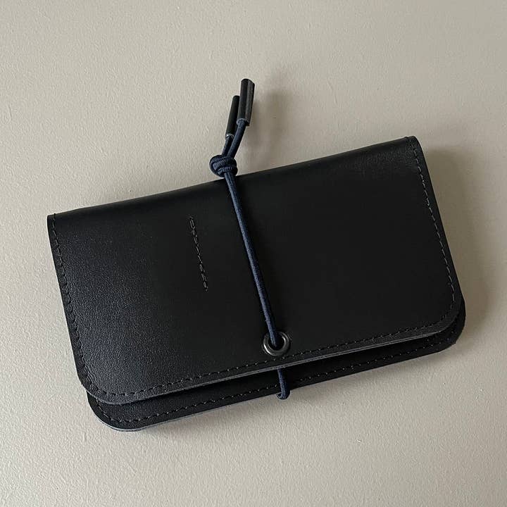 Black leather knot wallet with front flap and dark blue cord tie, smooth leather