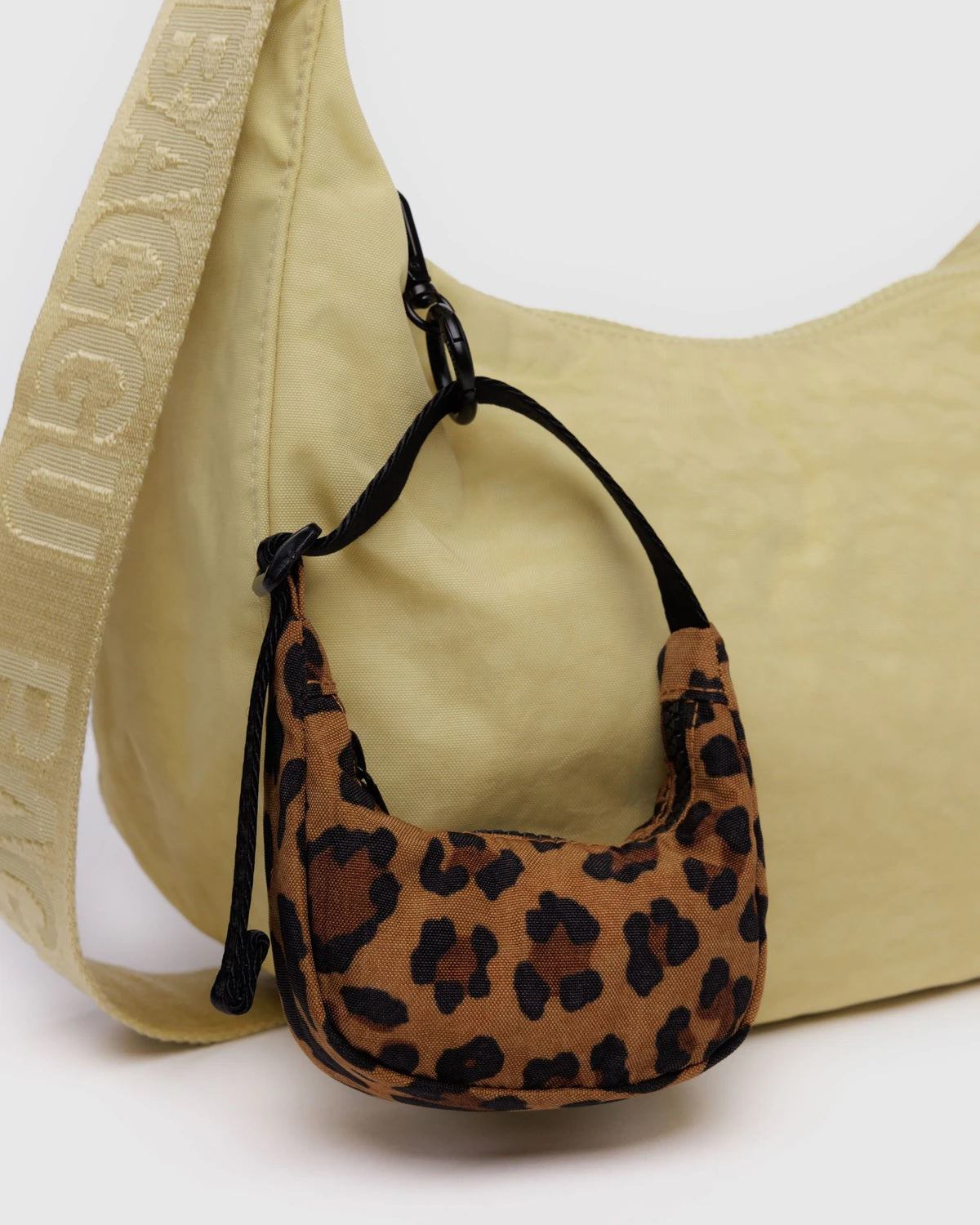 Leopard print crescent bag charm with black drawstring loops