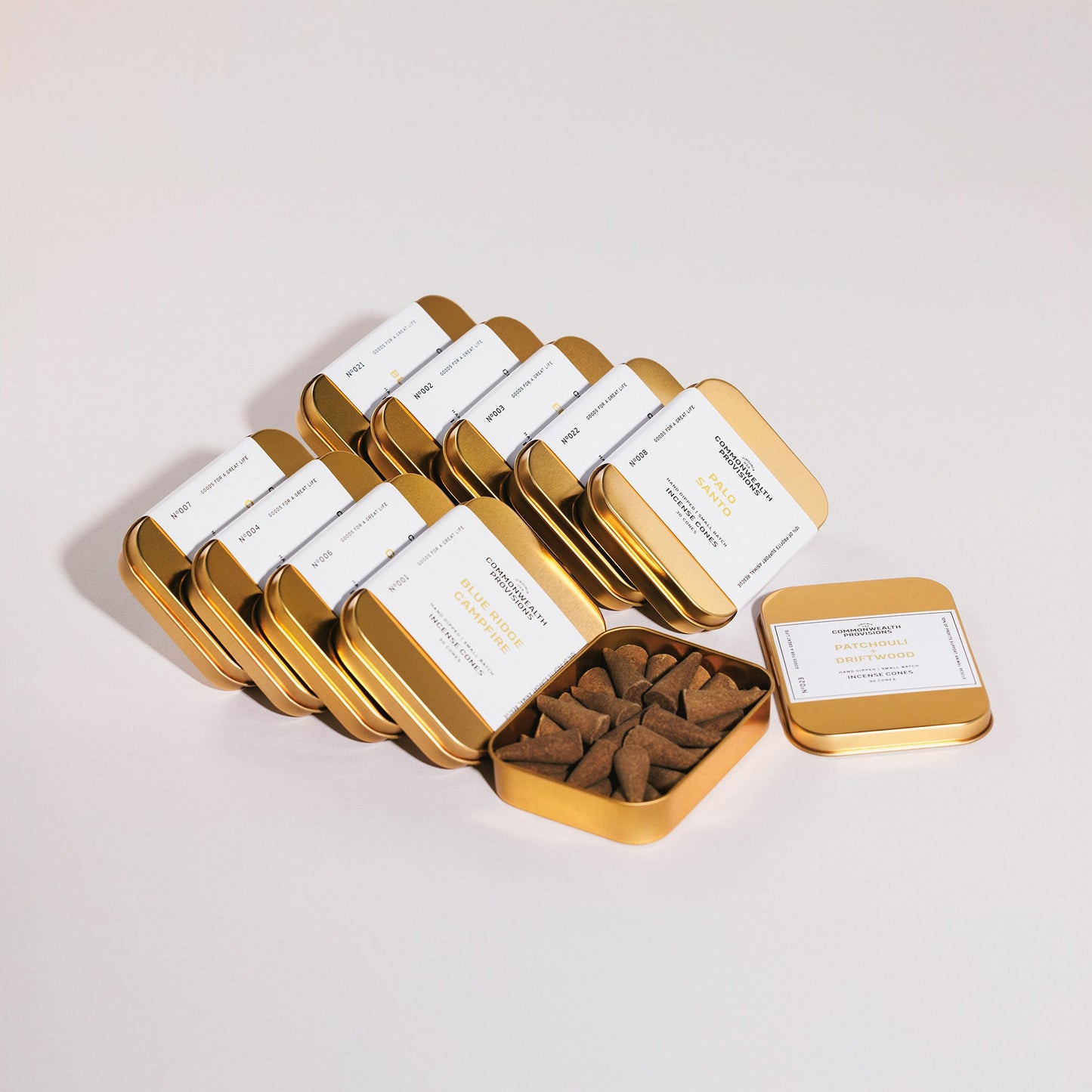 Hand-dipped incense cones in an open metal tray with a small cone assortment