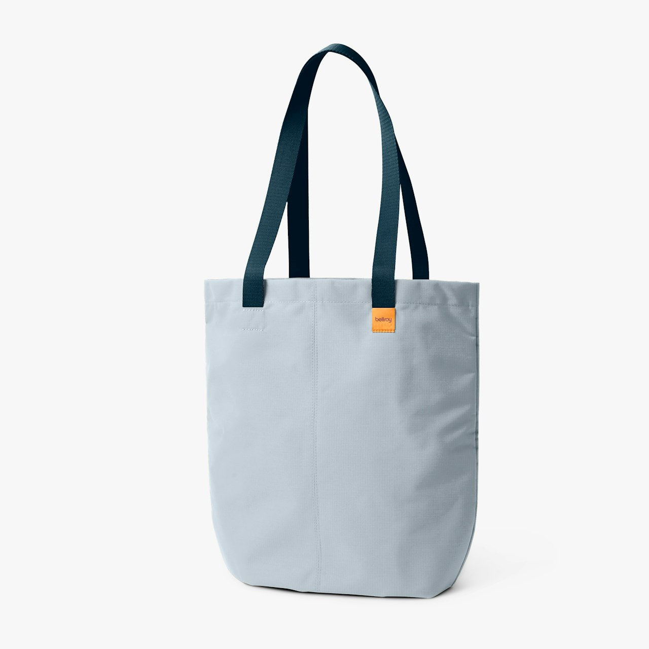 Light blue tote bag with dark teal handles and orange logo label