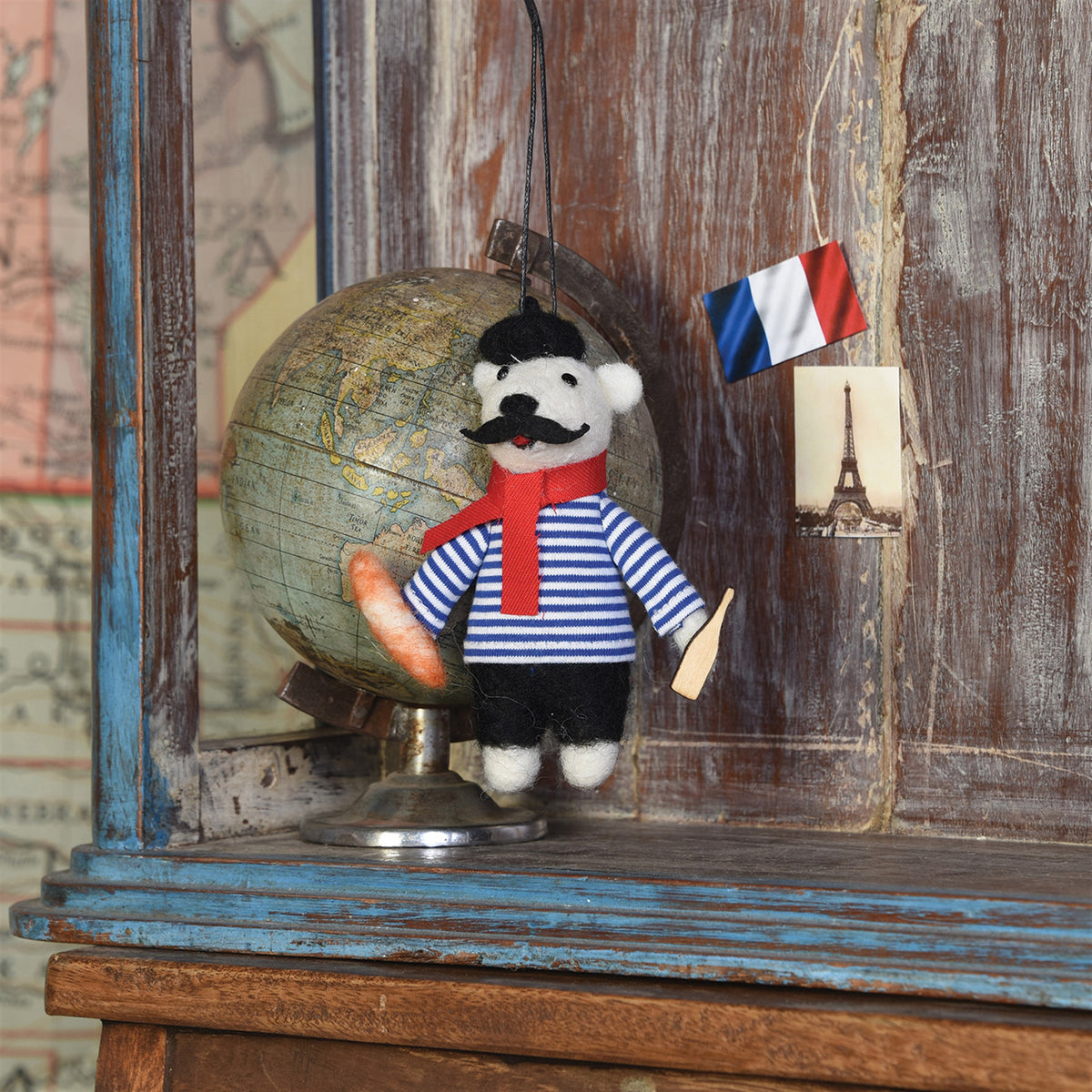Felt bear ornament holding small instrument, striped shirt and red scarf
