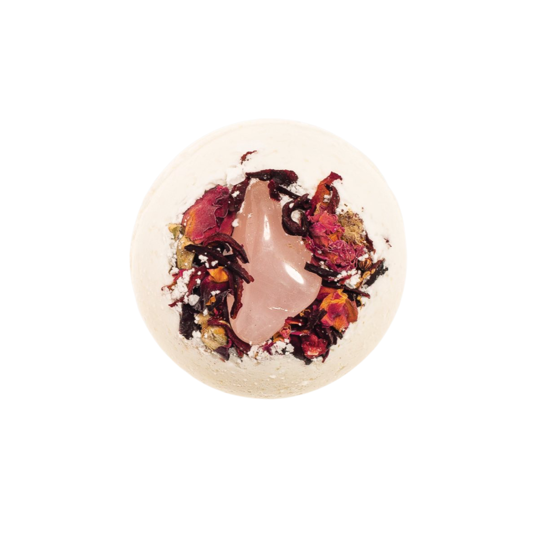 Bath bomb, round pale with pink-purple petals and glitter swirl.