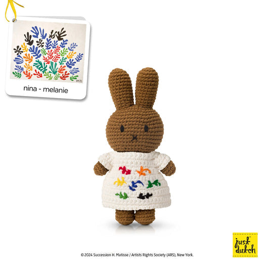 Crocheted bunny doll with brown ears and white embroidered dress