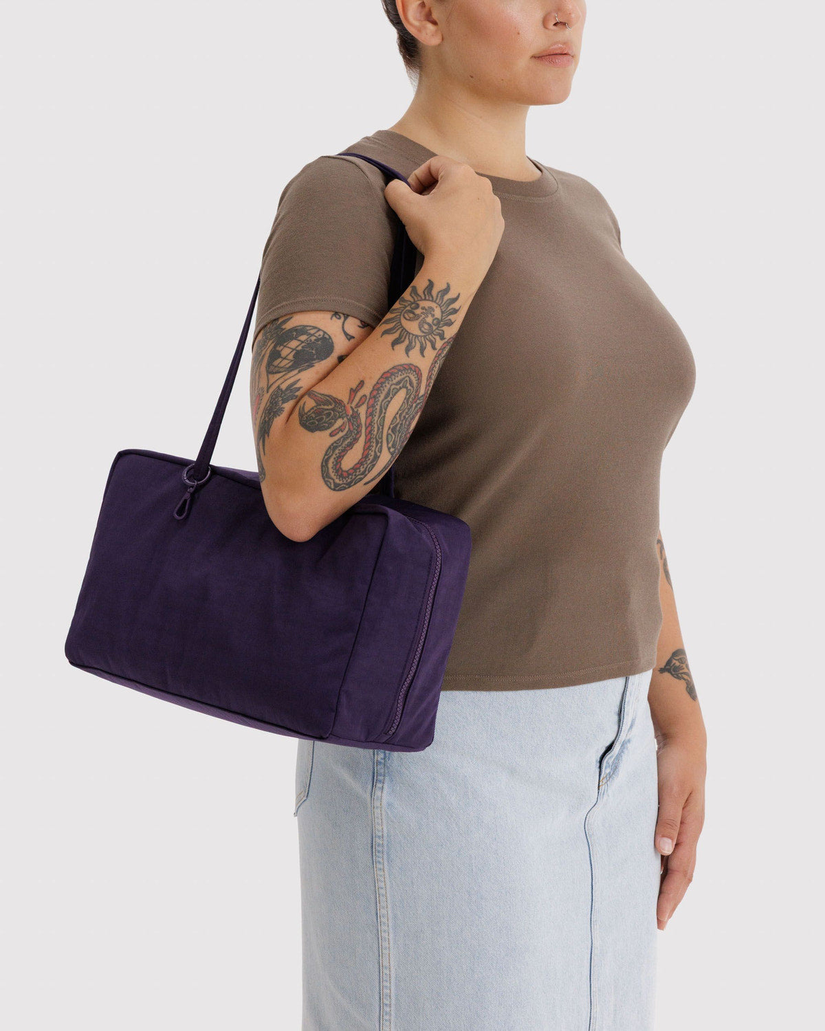 Purple nylon bowler bag on model, top zip and short handles