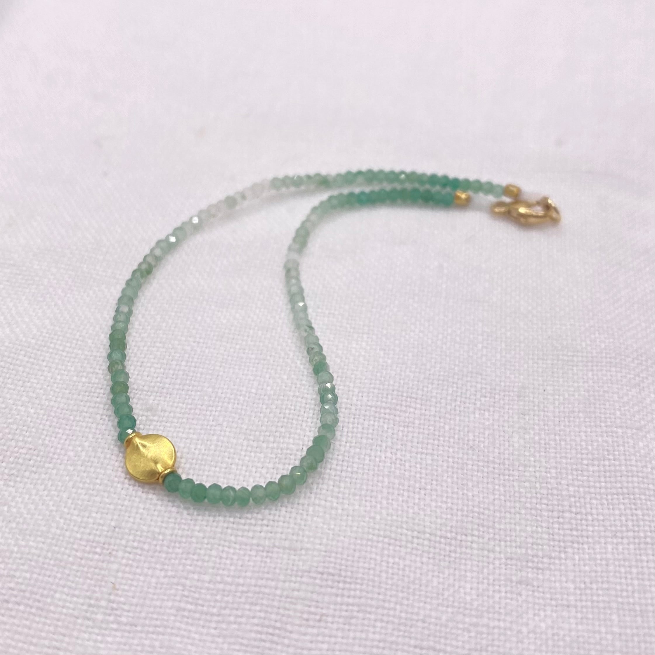 Green aventurine bead bracelet with gold toggle clasp, shown side view