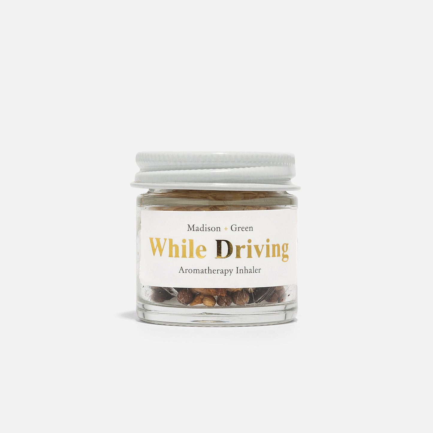 Aromatherapy inhaler jar labeled While Driving with white screw lid