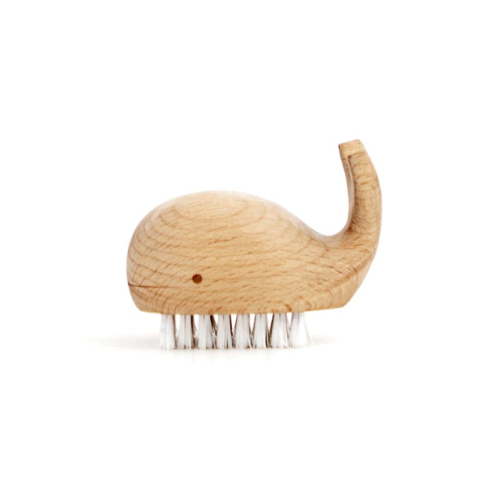 Wooden whale-shaped nail brush with white bristles on underside