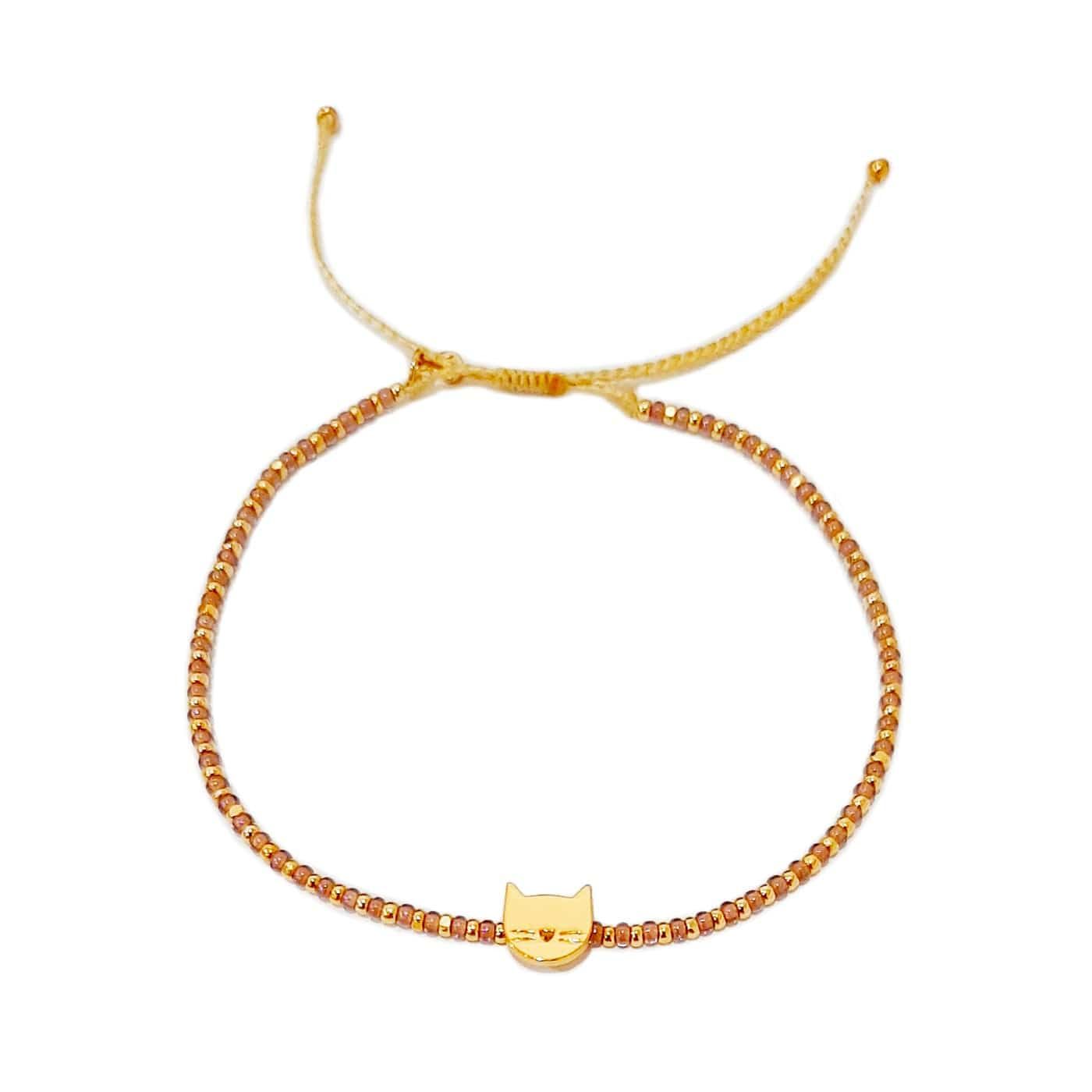 Gold-tone beaded bracelet with small cat charm centerpiece