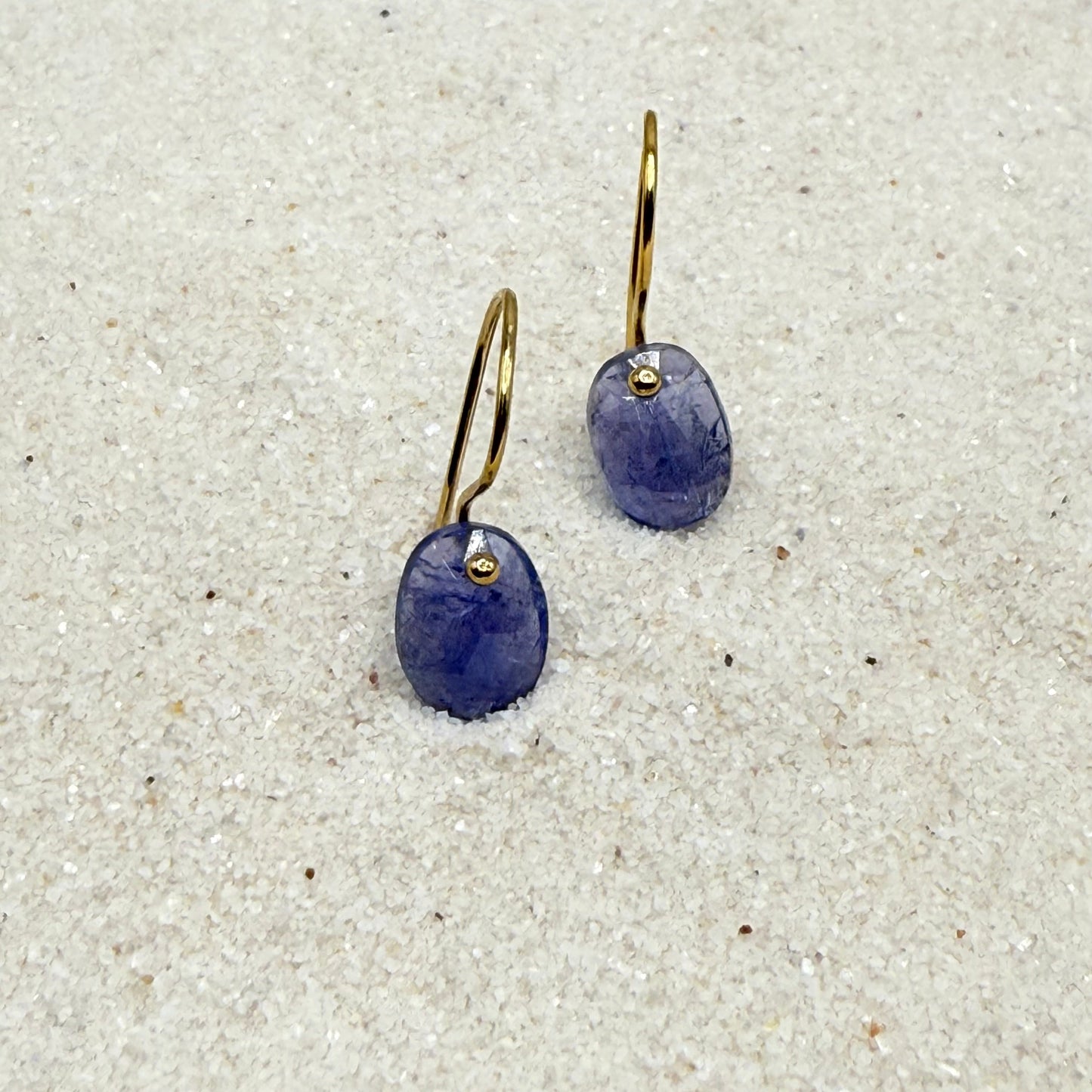 Blue oval gemstone drop earrings with small gold-tone mount