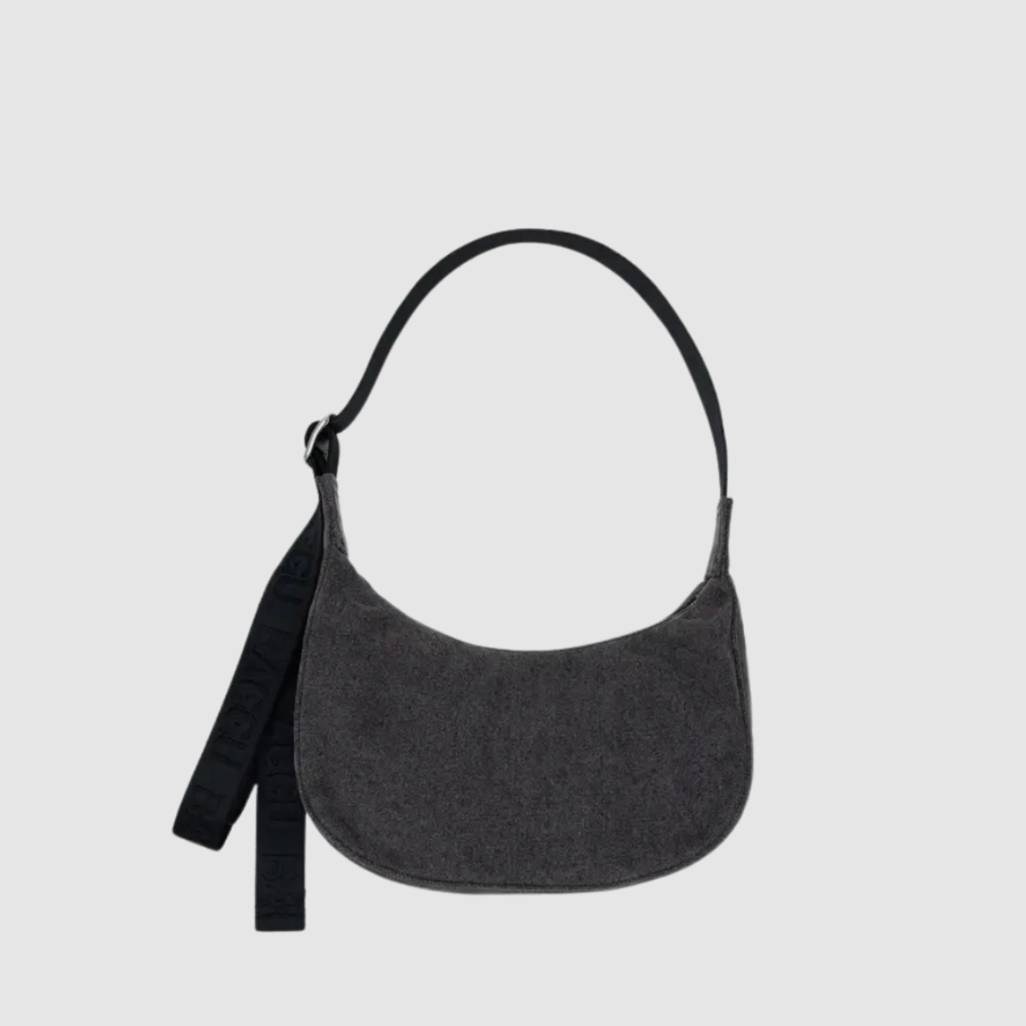 Washed black denim crescent hobo bag with top handle, zipper, and tassel pull