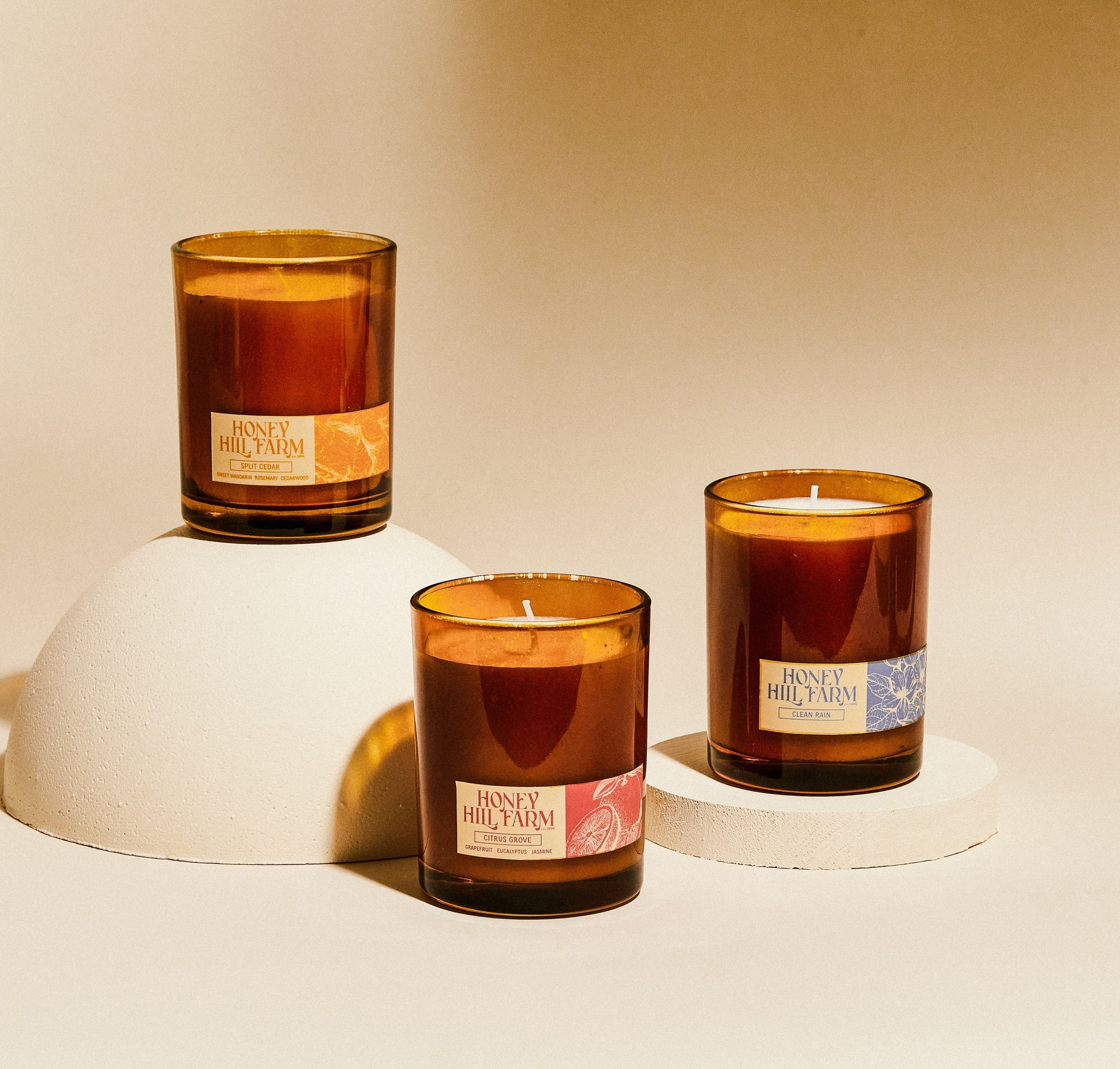 Amber glass candles trio with cotton wicks and Honey Hill Farm labels
