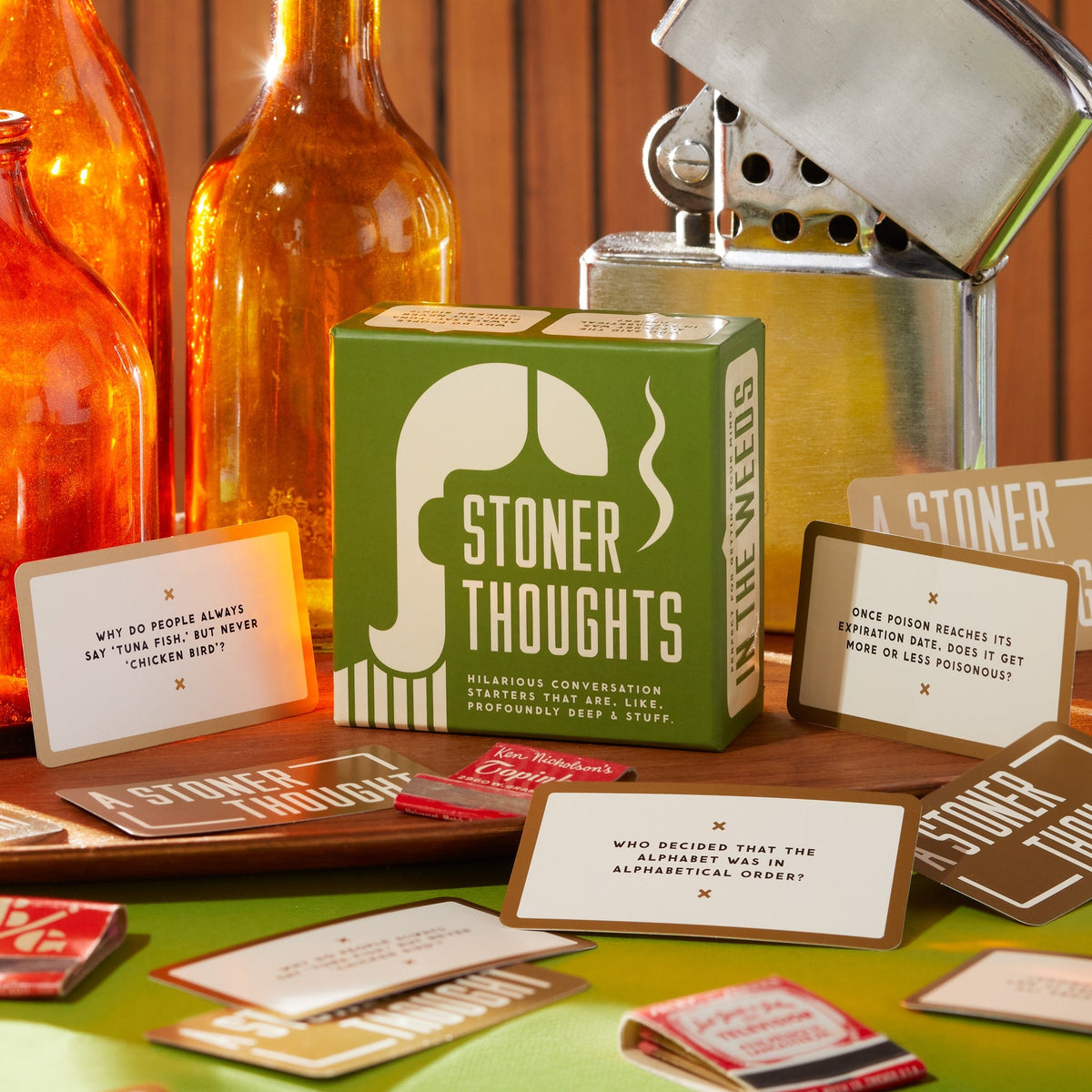Green Stoner Thoughts box with conversation starter cards on a wooden tabletop