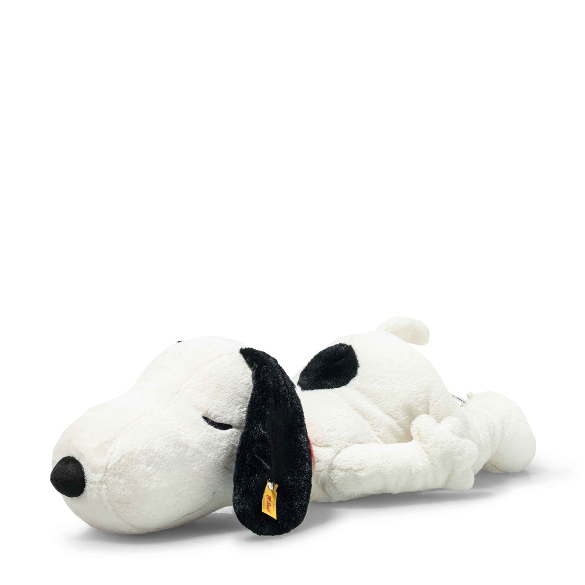 Snoopy lying plush, white with black ear patches and sleepy embroidered eyes