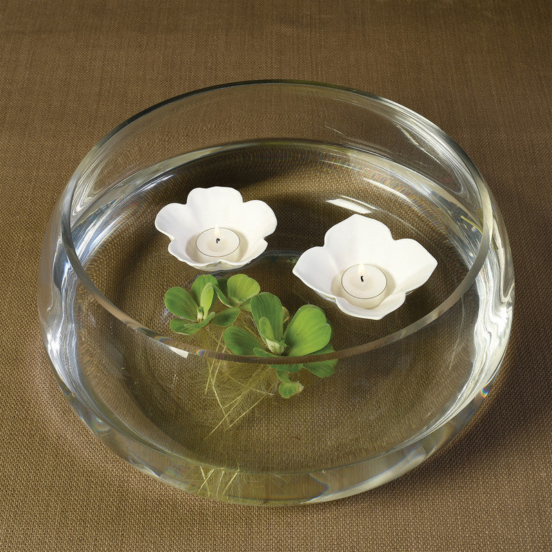 White hibiscus floating tealight holders with two candles in a glass bowl