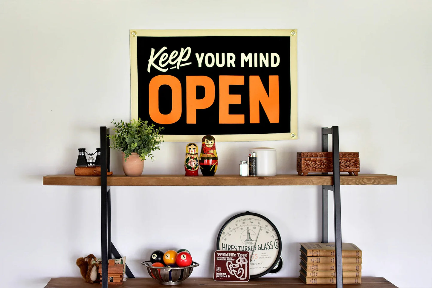 Camp flag with white 'Keep your mind' and large orange 'OPEN' on black, brass grommets