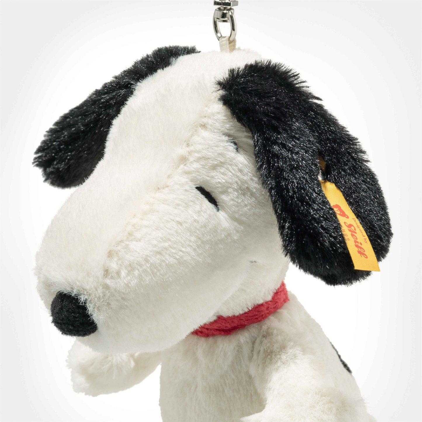 Plush Snoopy bag charm pendant close-up, metal keyring, black ear and red collar