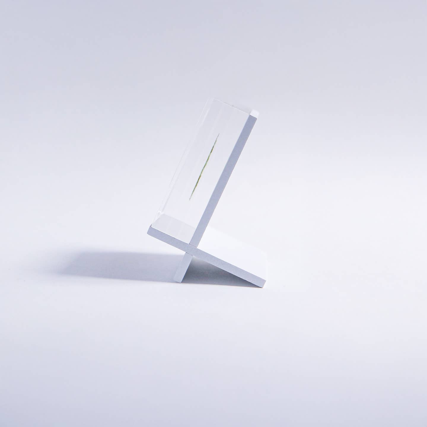 White freestanding tile stand with angled frame and base