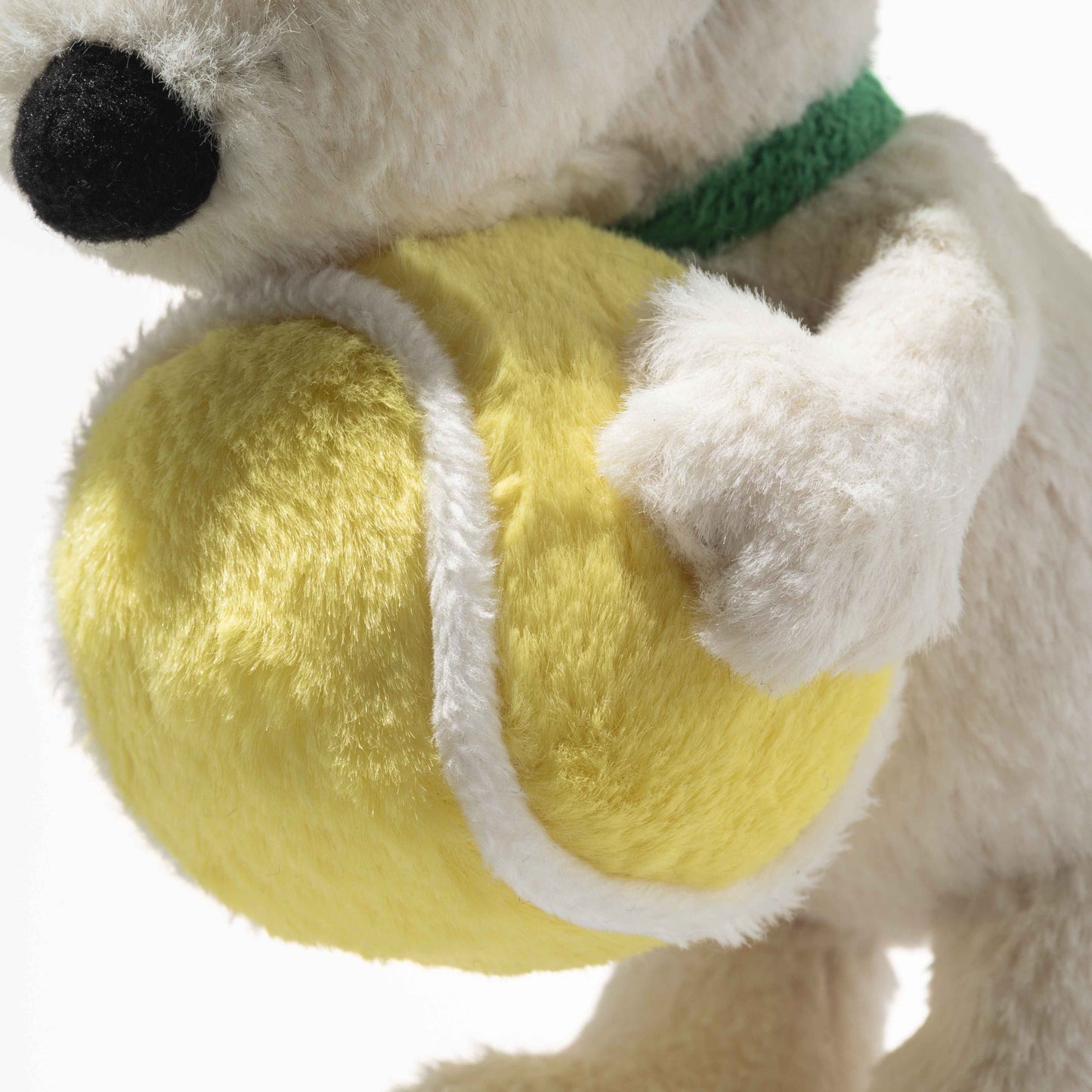 Plush Snoopy-style keychain detail, yellow tennis ball and white plush paw