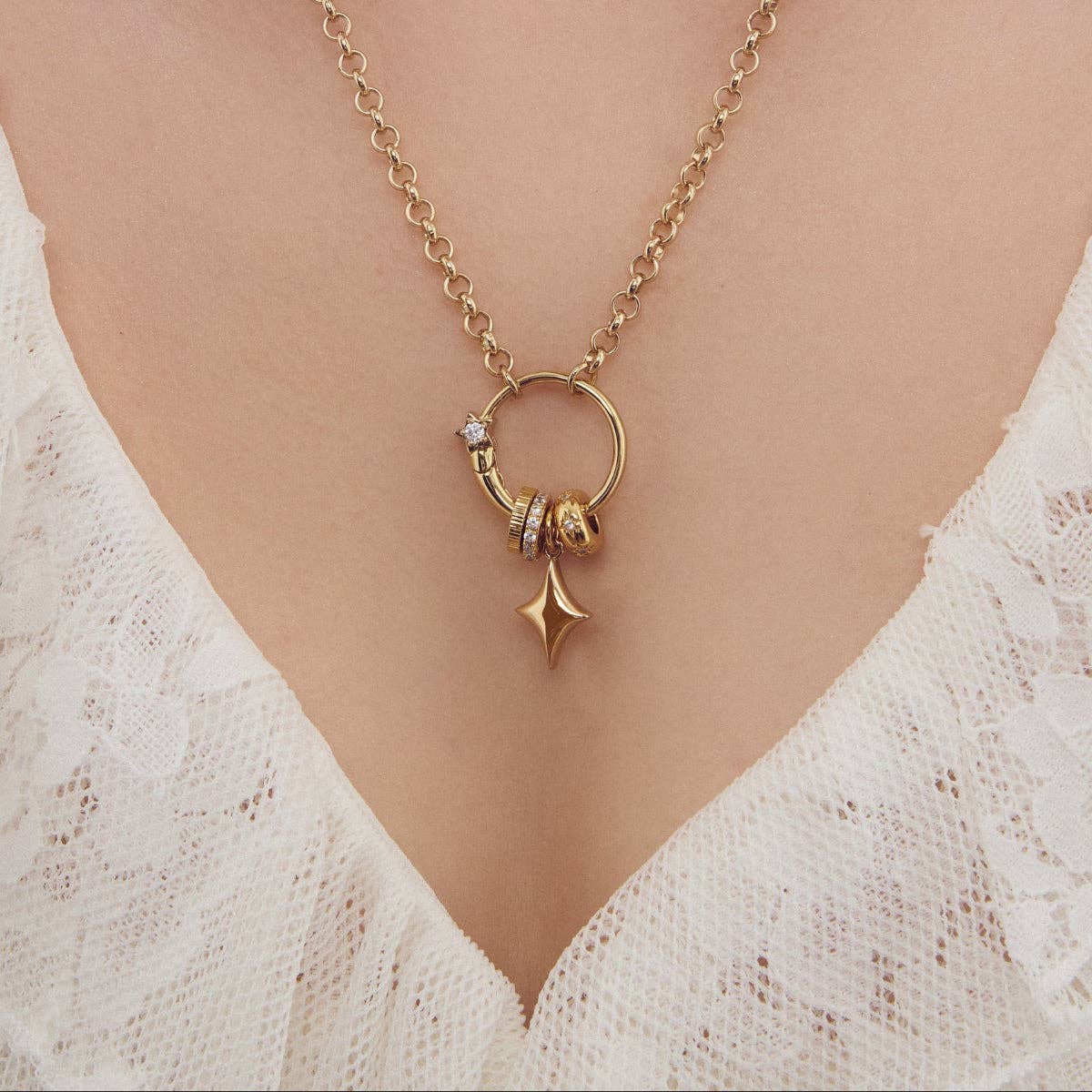 Gold star charm pendant on chain necklace with ring clasp and small accents