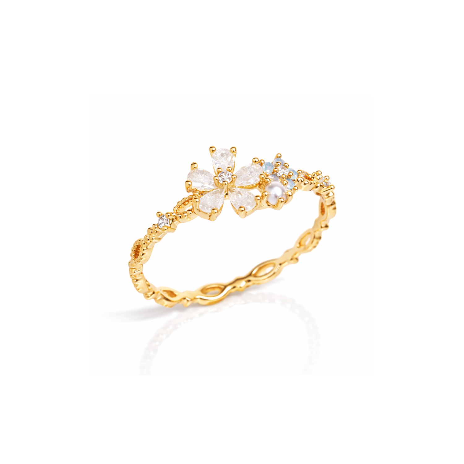 Gold-tone flower ring with white petals and small blue stone accents