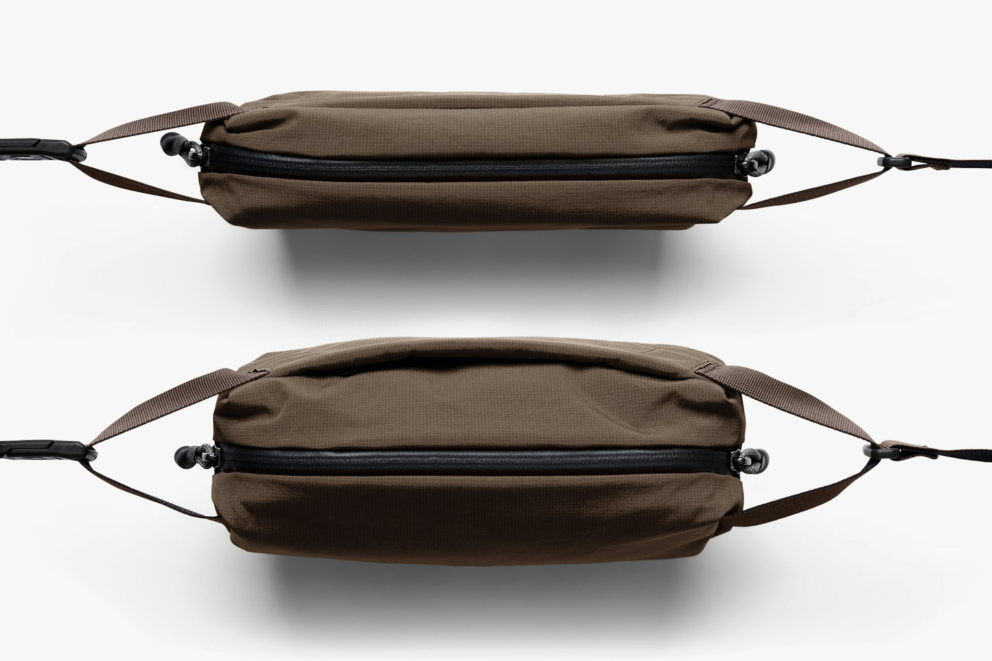 Mini sling bag shown from the side with rounded shape and two strap attachment points.