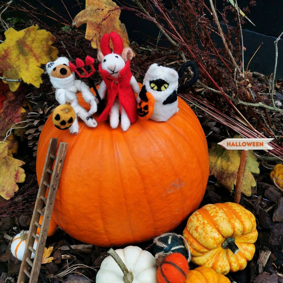 Felt devil mouse decoration set on Halloween pumpkins with pitchforks